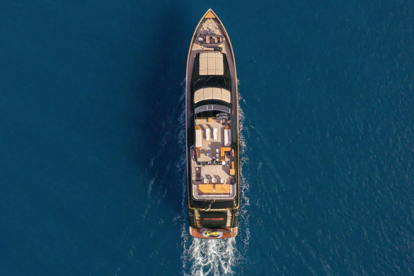 Aerial view of a luxurious yacht cruising through clear blue waters. aboard CAN'T REMEMBER Yacht for Sale