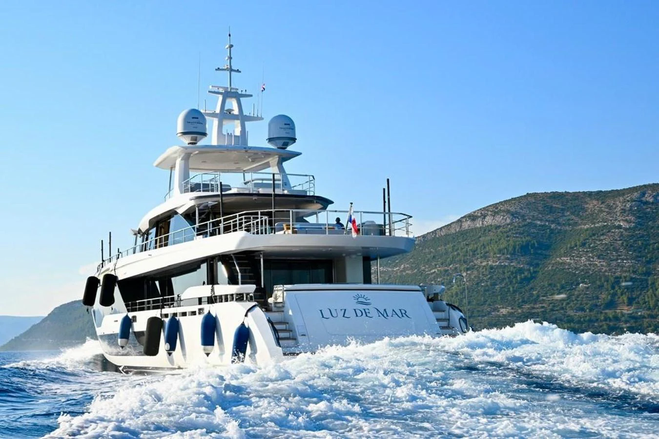 A luxurious yacht cruises through the water, showcasing its sleek design and spacious decks. aboard LUZ DE MAR Yacht for Sale