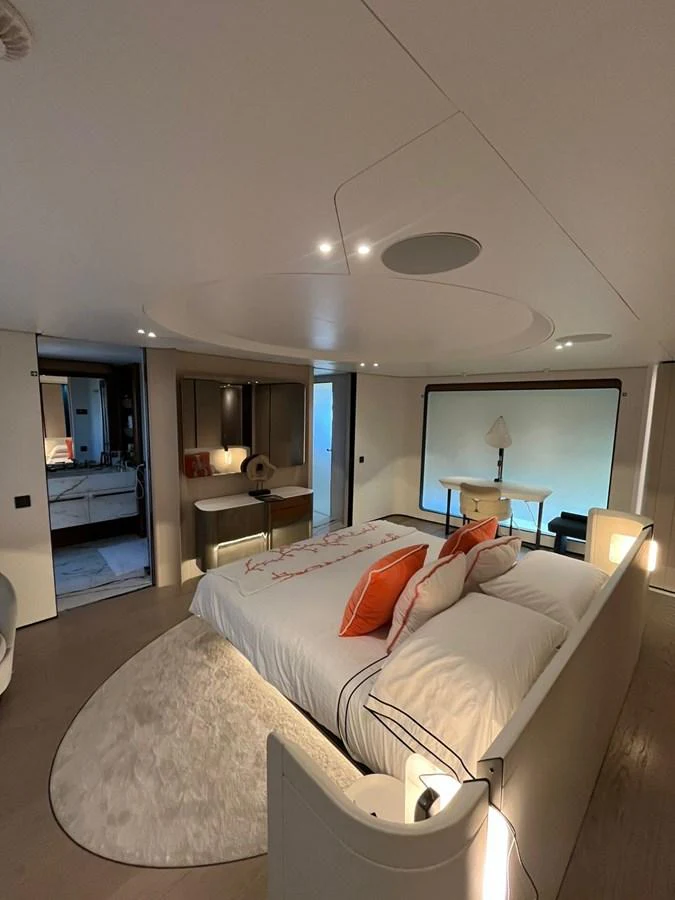 The stateroom features a luxurious bed with elegant decor and ample natural light. aboard LUZ DE MAR Yacht for Sale