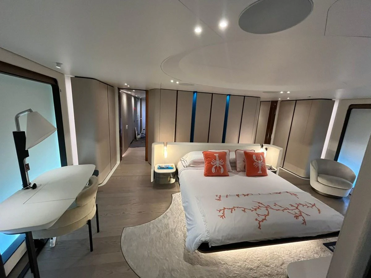 The master stateroom features a luxurious bed with elegant decor and ample natural light. aboard LUZ DE MAR Yacht for Sale
