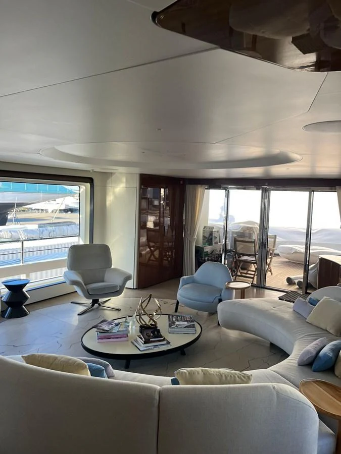 The yacht's salon features modern furnishings with ample natural light and a serene ambiance. aboard LUZ DE MAR Yacht for Sale