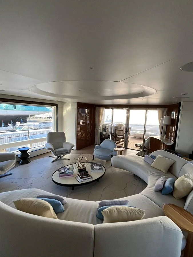 The salon features a spacious and elegant seating area with large windows offering stunning views. aboard LUZ DE MAR Yacht for Sale