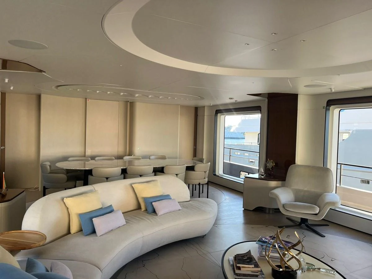 The salon features elegant seating and large windows, creating a bright and inviting space. aboard LUZ DE MAR Yacht for Sale