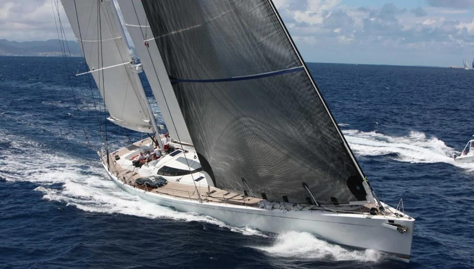 A sleek sailing yacht glides gracefully over the open sea, showcasing its impressive sails and streamlined design. aboard MARI-CHA III Yacht for Sale