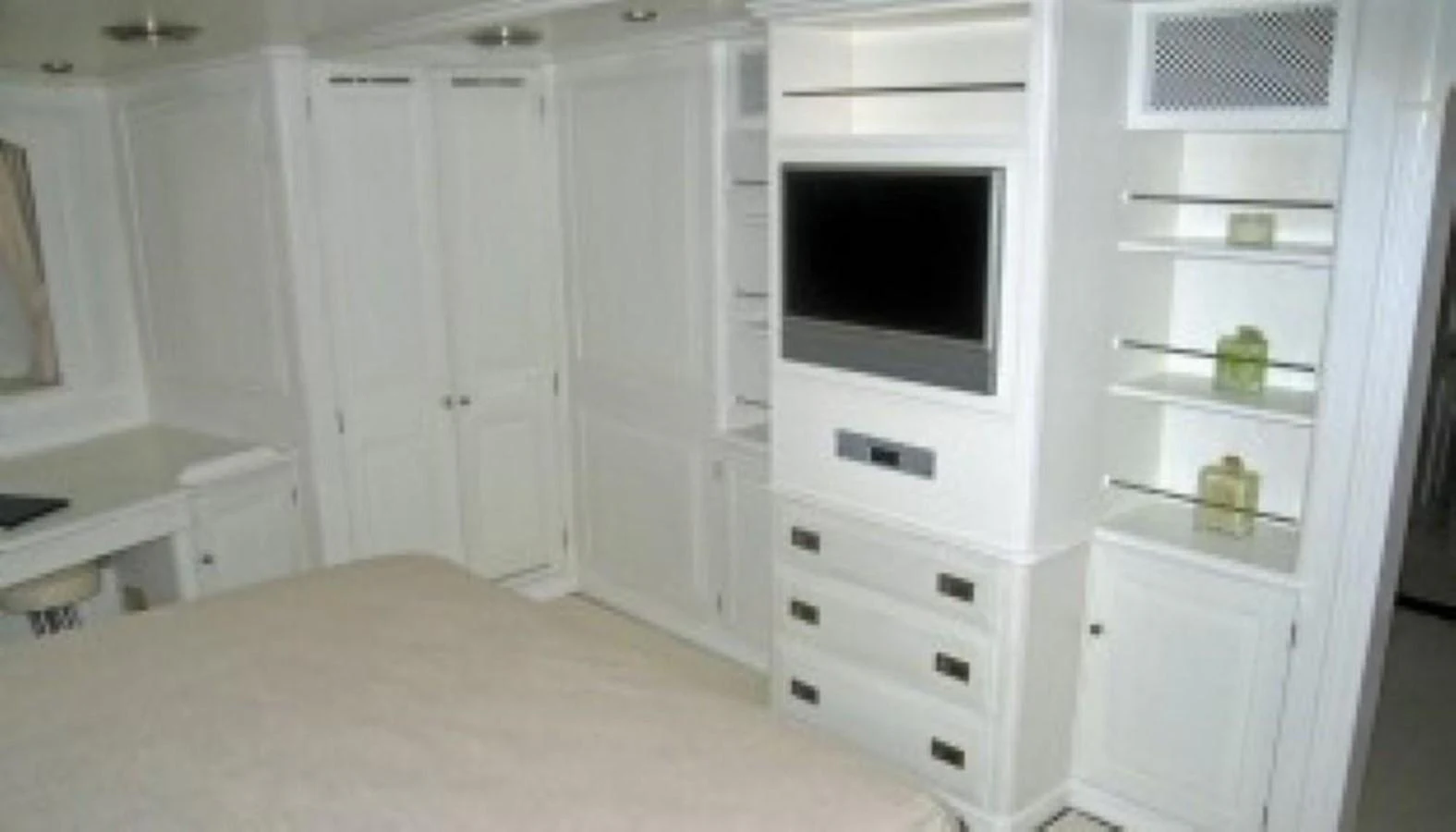 A luxurious stateroom featuring built-in cabinetry and a flat-screen TV. aboard MARI-CHA III Yacht for Sale