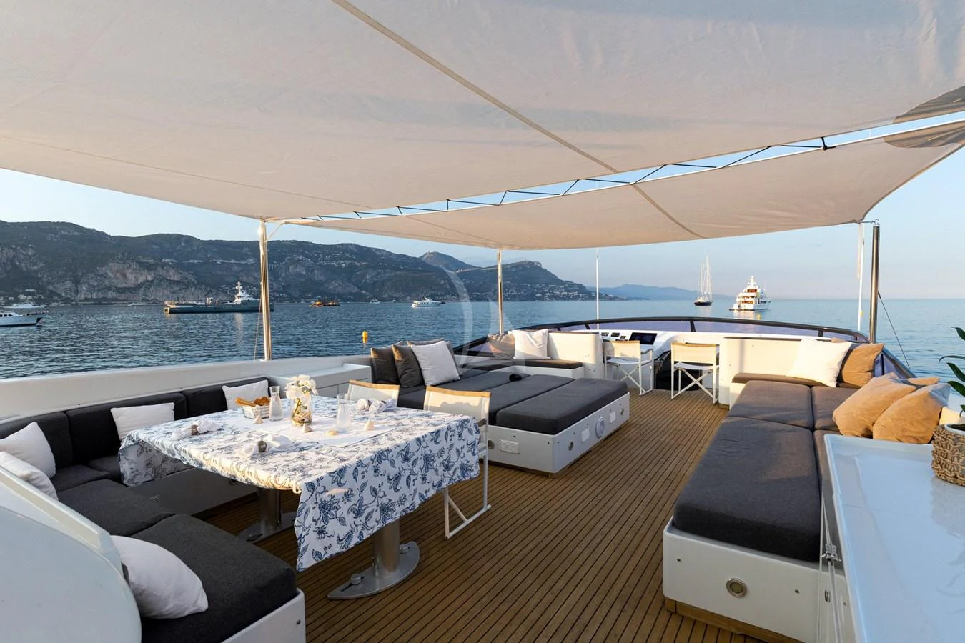 The aft deck offers a spacious and inviting area for alfresco dining and lounging with stunning sea views. aboard TALILA Yacht for Sale