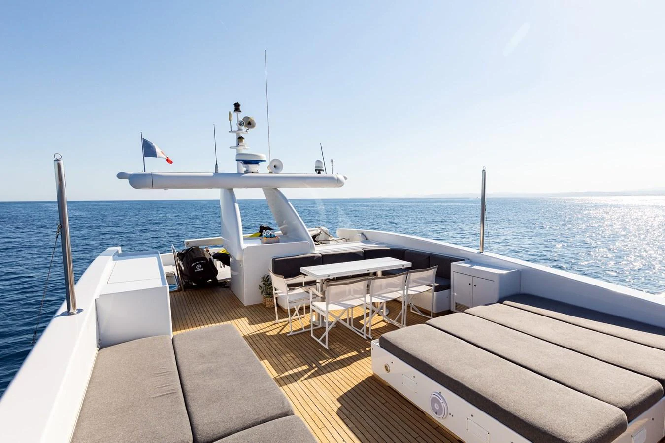 The sundeck offers ample seating and dining space with a stunning ocean view. aboard TALILA Yacht for Sale