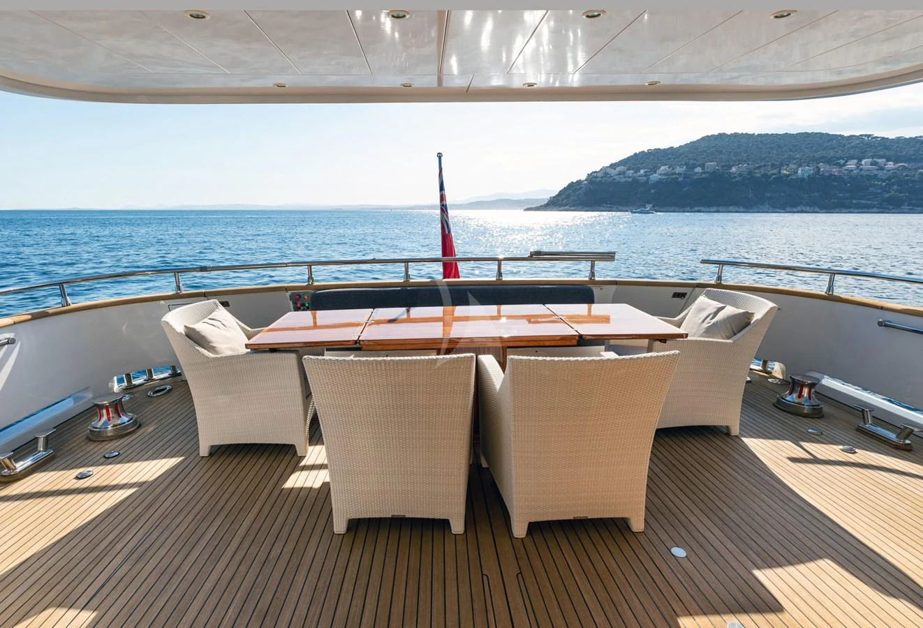 The aft deck offers a serene dining area with stunning ocean views. aboard TALILA Yacht for Sale