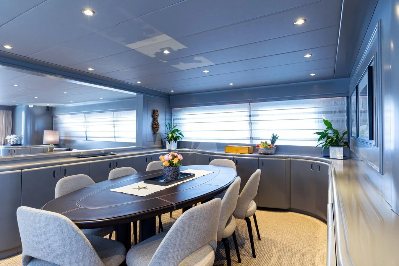 The yacht's dining area features a sleek, modern design with a large table and comfortable seating. aboard TALILA Yacht for Sale