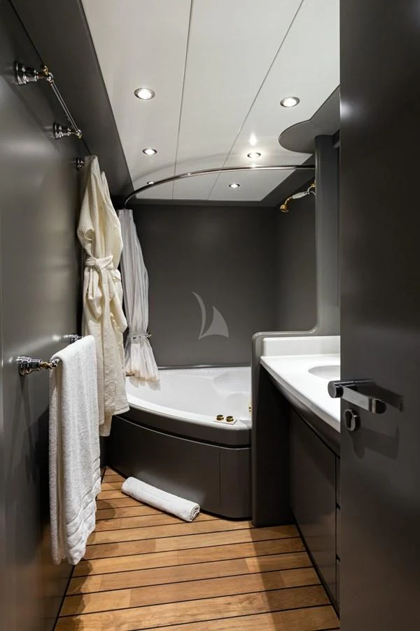 A sleek and modern yacht bathroom with a luxurious bathtub and elegant fixtures. aboard TALILA Yacht for Sale