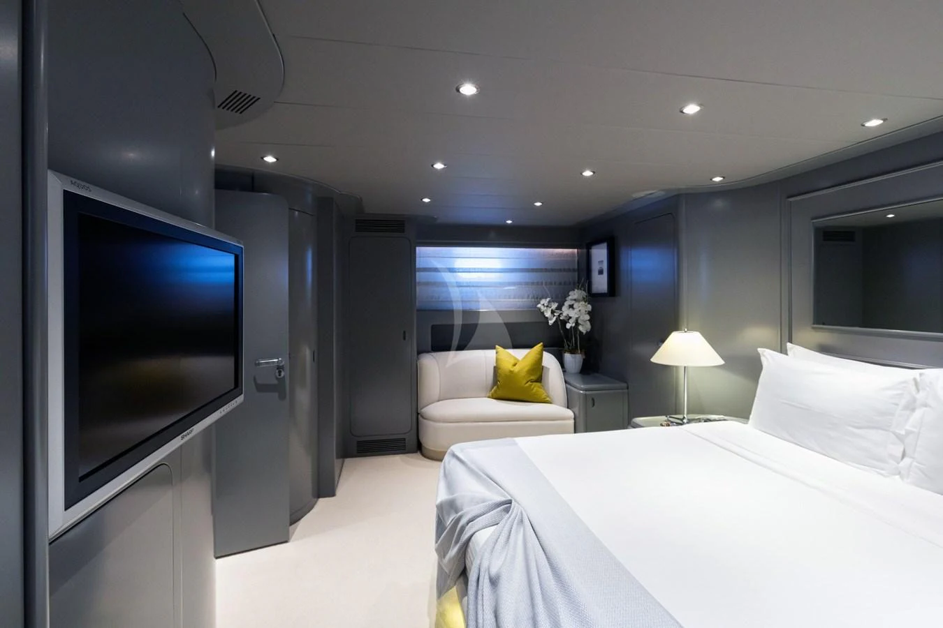 The stateroom features a modern design with a comfortable bed, a cozy seating area, and a flat-screen TV. aboard TALILA Yacht for Sale