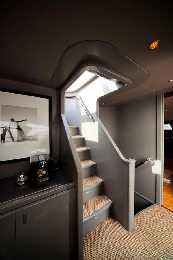 A stylish staircase with modern design elements and a skylight above. aboard TALILA Yacht for Sale