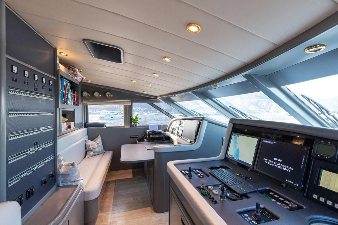 The helm station features advanced navigation equipment and a comfortable seating area with panoramic views. aboard TALILA Yacht for Sale