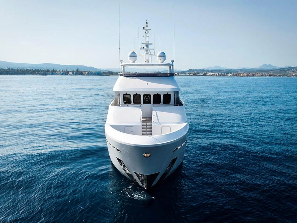 A stunning yacht is captured head-on, showcasing its sleek design and pristine condition on calm waters. aboard BANDIDO Yacht for Sale