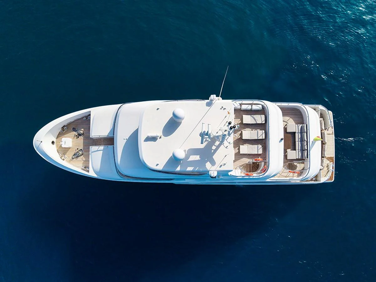 Aerial view of a sleek yacht cruising on calm blue waters. aboard BANDIDO Yacht for Sale
