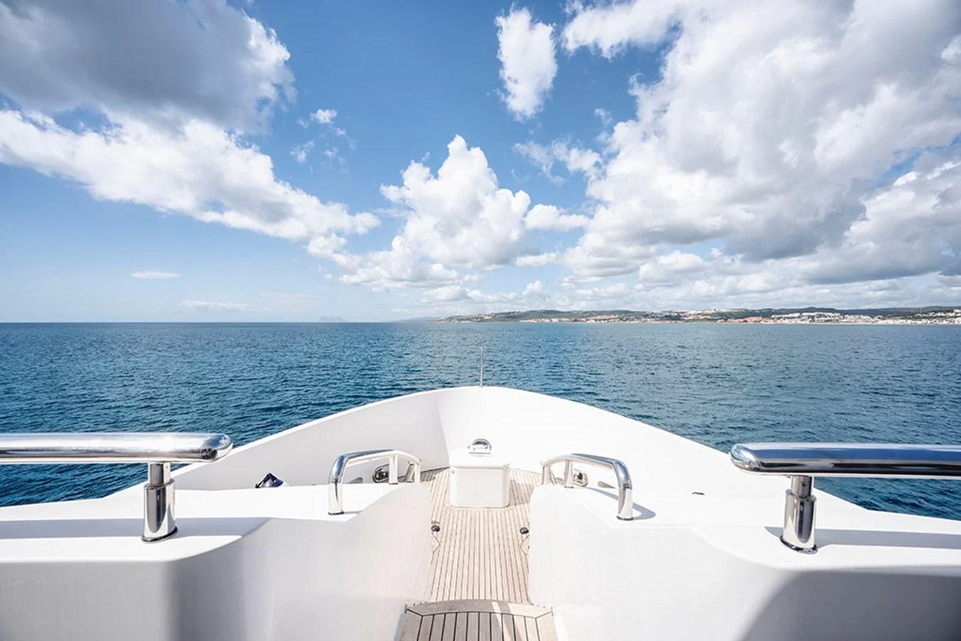 The yacht's bow offers a stunning view of the open sea under a bright, partly cloudy sky. aboard BANDIDO Yacht for Sale