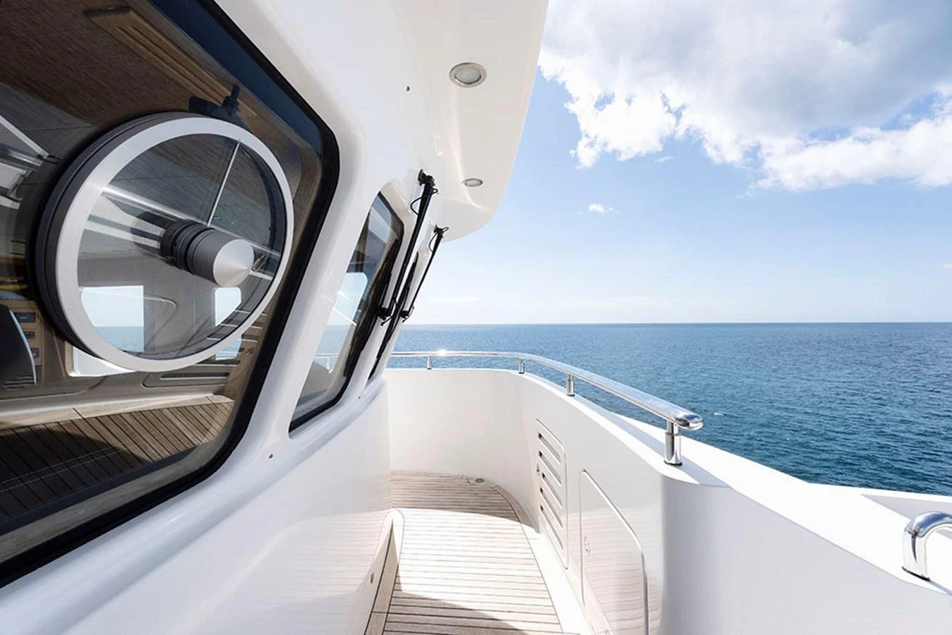 A pristine yacht deck with sleek lines and a stunning ocean view. aboard BANDIDO Yacht for Sale
