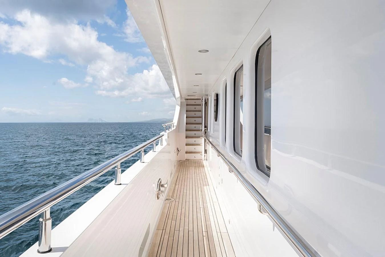 The yacht's side deck offers a serene walk with stunning ocean views. aboard BANDIDO Yacht for Sale