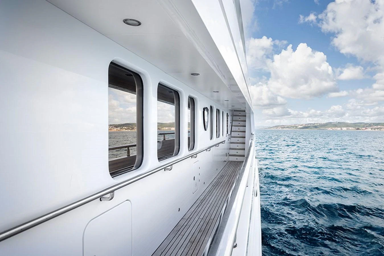 A sleek yacht exterior with a view of the ocean and clear skies. aboard BANDIDO Yacht for Sale