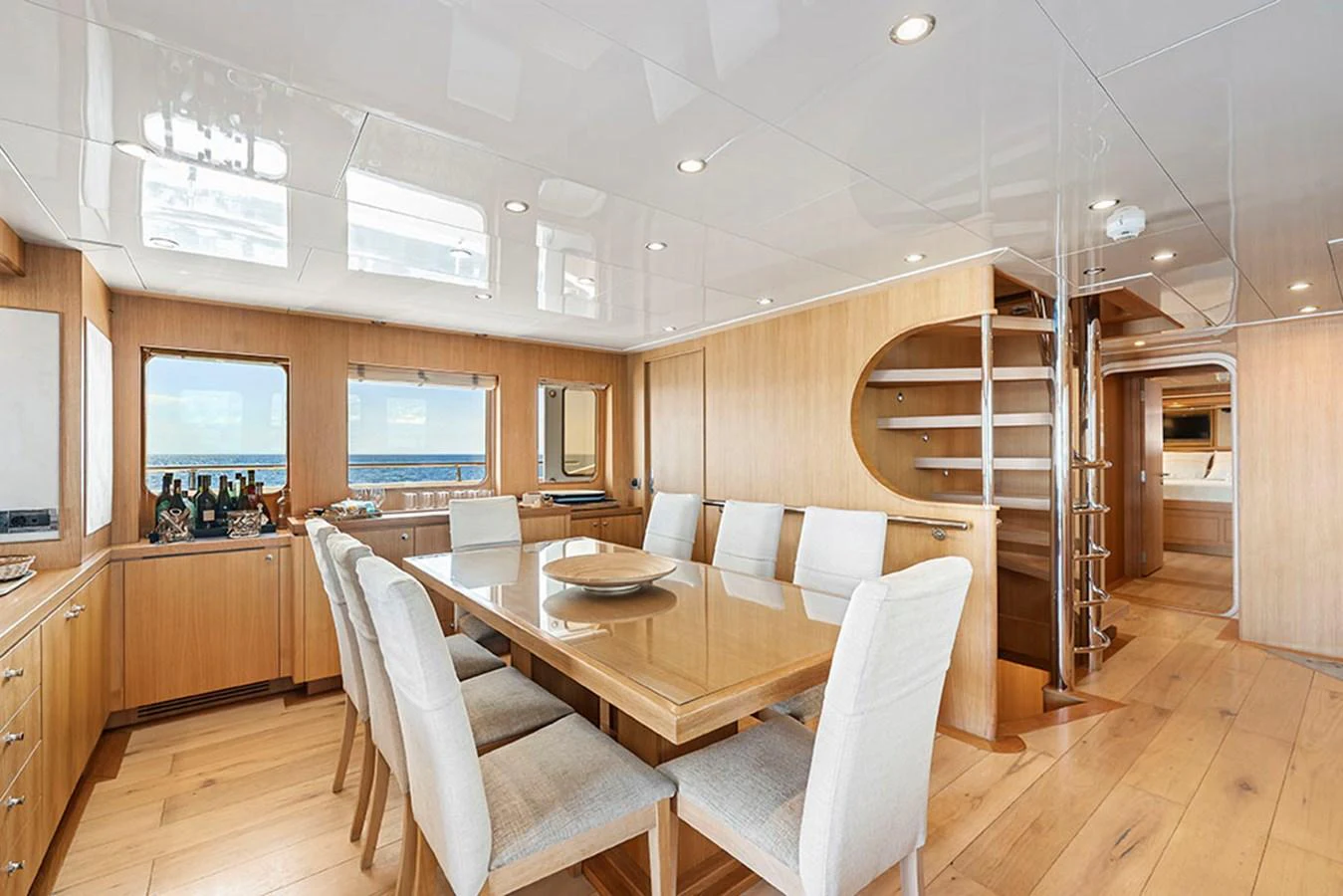 The yacht's dining area features a spacious table with comfortable seating and elegant wooden finishes. aboard BANDIDO Yacht for Sale
