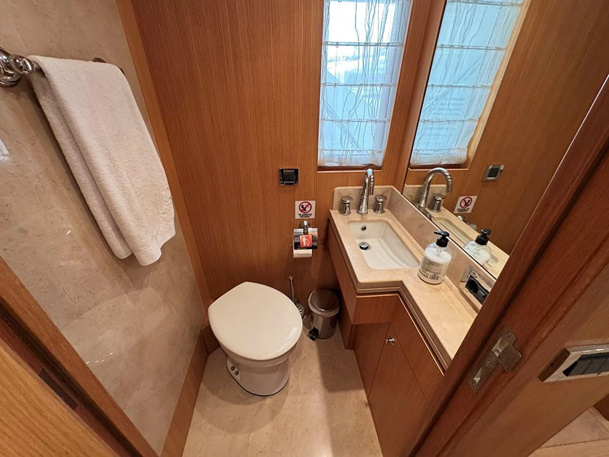 A compact and well-appointed yacht bathroom with modern fixtures and wooden accents. aboard BANDIDO Yacht for Sale