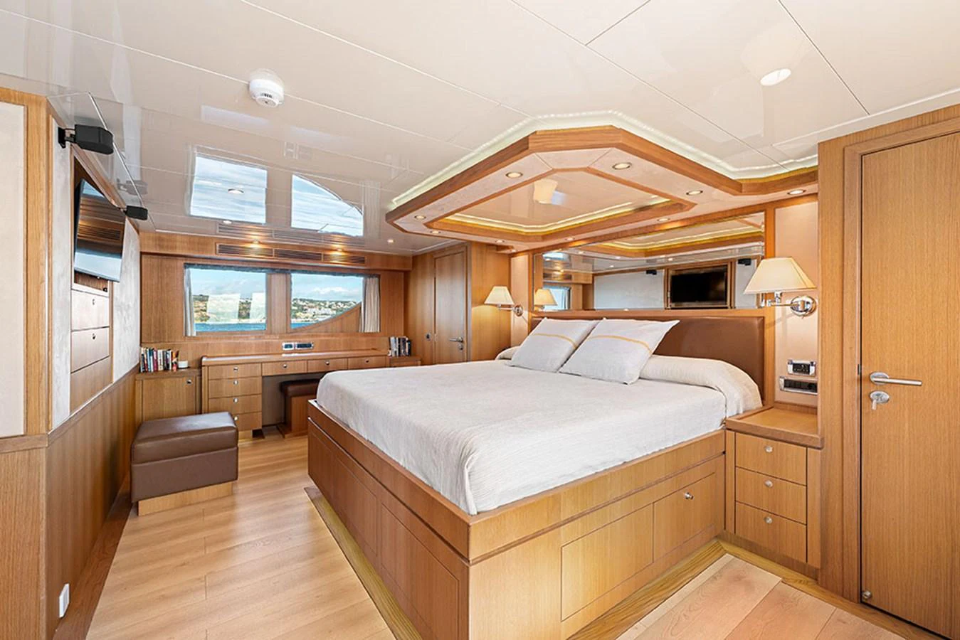 The master stateroom features a spacious bed, ample storage, and elegant wood finishes. aboard BANDIDO Yacht for Sale