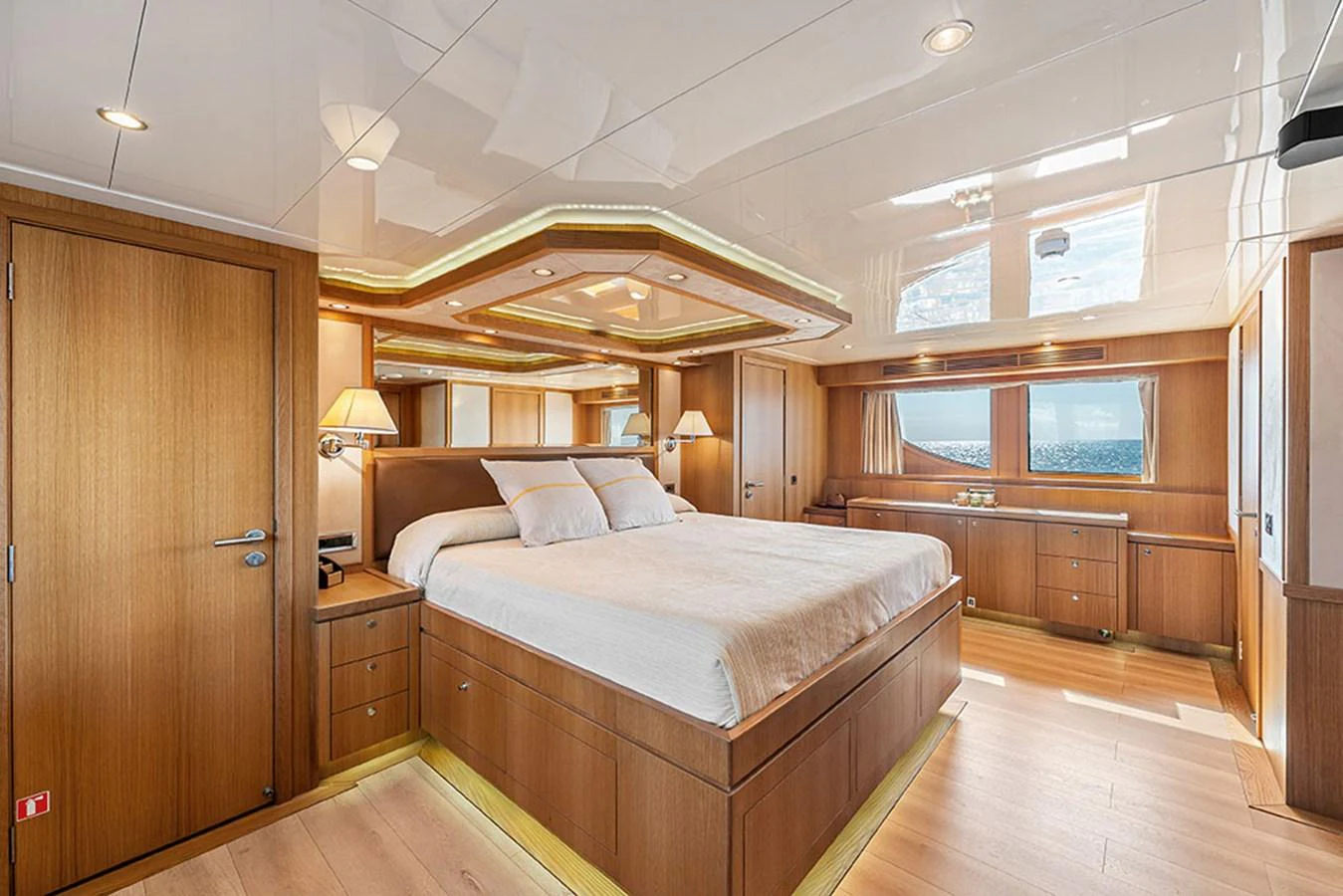 The master stateroom features a spacious bed, elegant wood finishes, and ample natural light. aboard BANDIDO Yacht for Sale