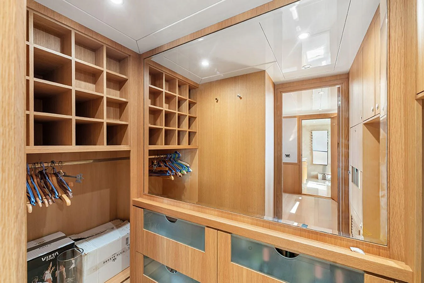 A spacious and well-organized yacht closet with ample storage and a large mirror. aboard BANDIDO Yacht for Sale