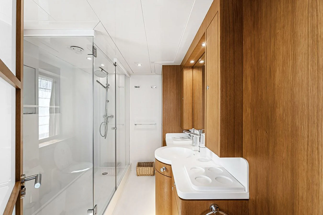 The yacht's bathroom features a sleek design with wooden cabinetry and a spacious glass-enclosed shower. aboard BANDIDO Yacht for Sale