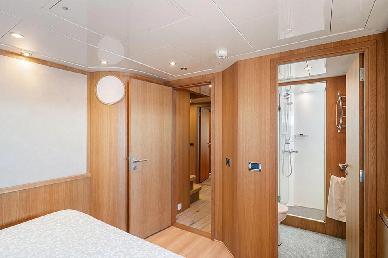 The guest cabin features a cozy bed and an en-suite bathroom with modern fixtures. aboard BANDIDO Yacht for Sale