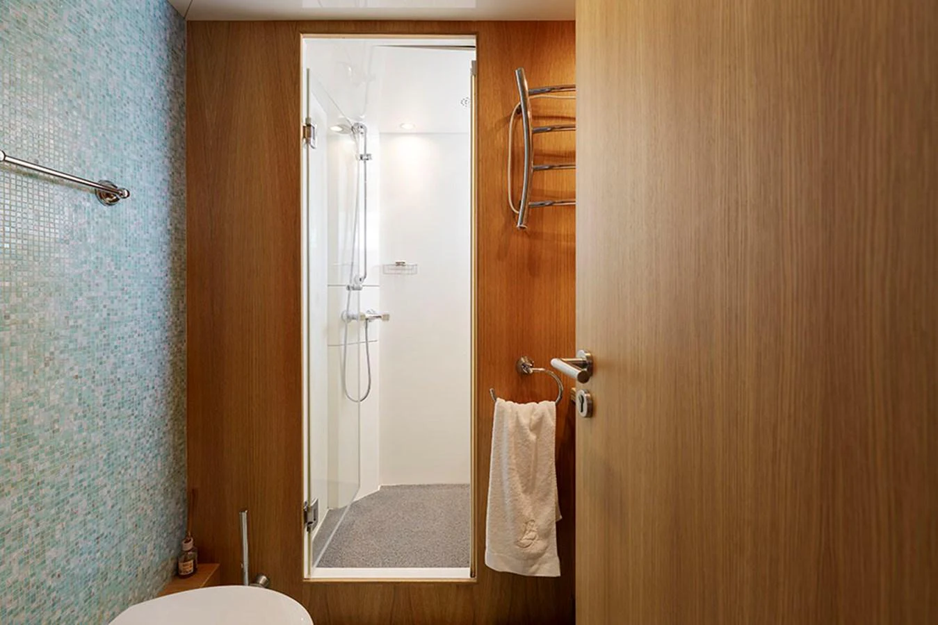 A modern yacht bathroom with a sleek shower and wooden accents. aboard BANDIDO Yacht for Sale