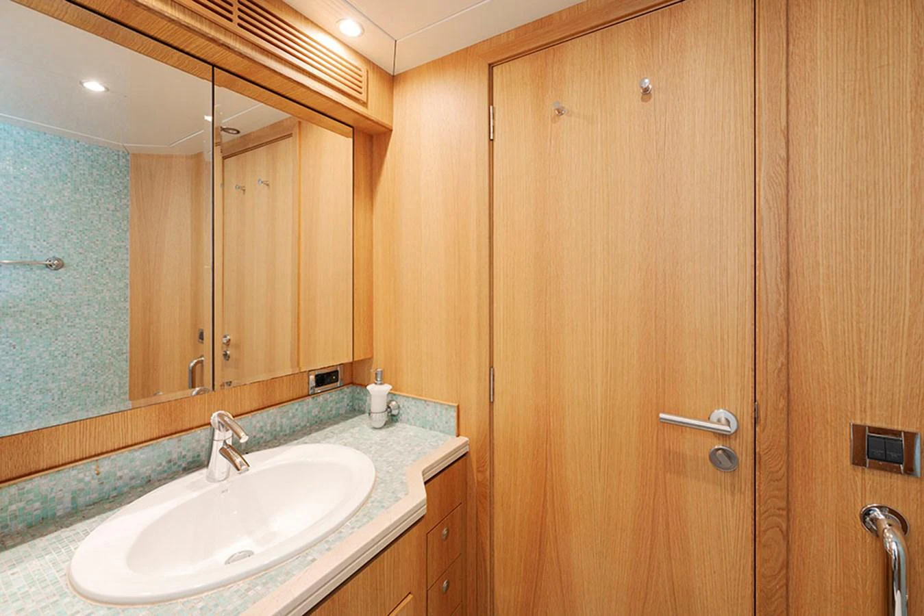The yacht's bathroom features a sleek design with a modern sink and wooden cabinetry. aboard BANDIDO Yacht for Sale