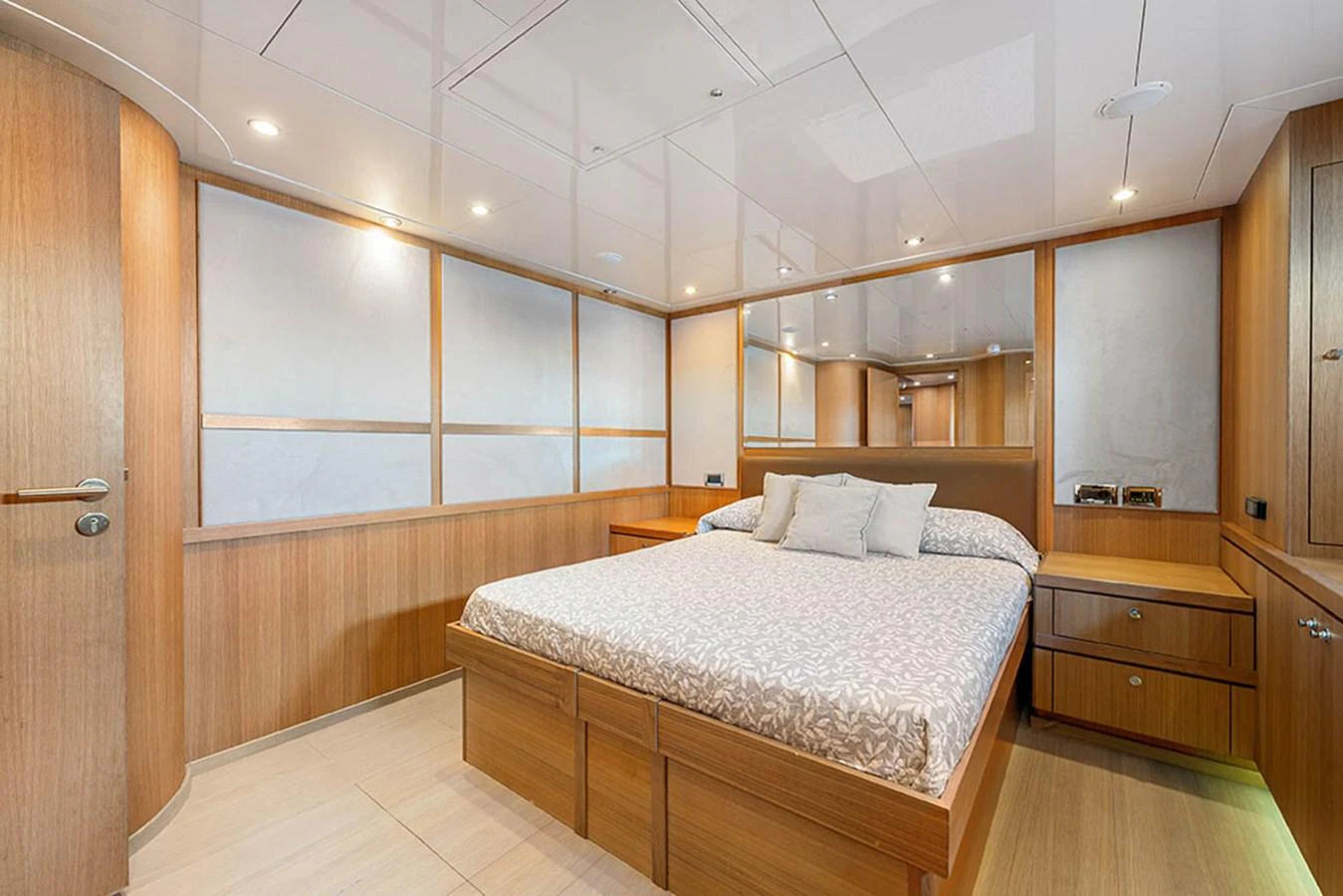 A serene stateroom featuring a comfortable bed and elegant wood paneling. aboard BANDIDO Yacht for Sale