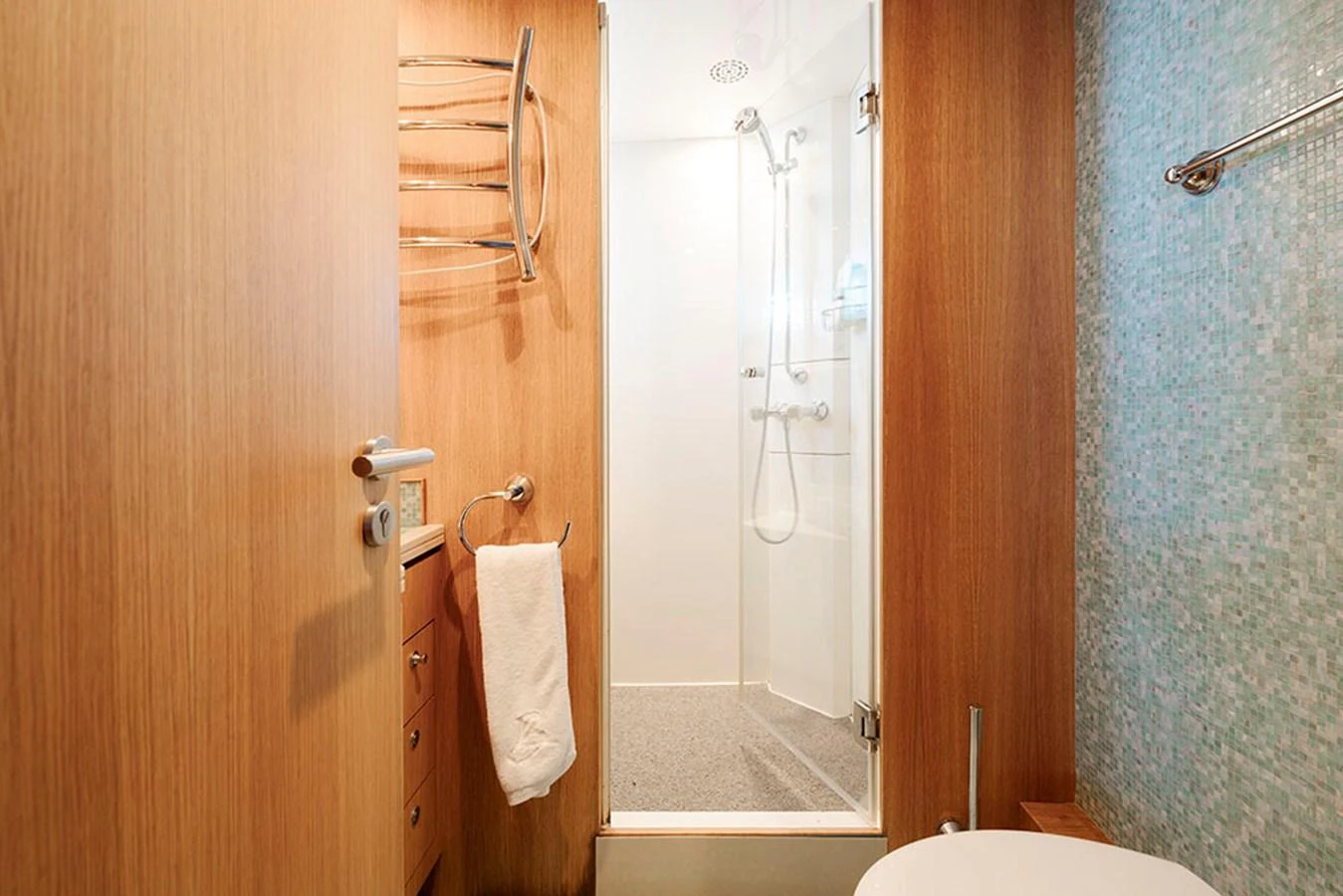 A well-appointed yacht bathroom featuring a shower, wooden cabinetry, and modern fixtures. aboard BANDIDO Yacht for Sale