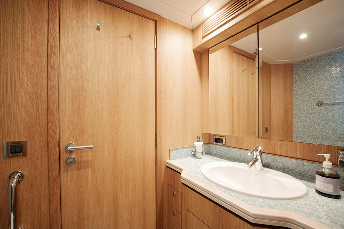 A well-appointed yacht bathroom featuring wood paneling and a modern sink. aboard BANDIDO Yacht for Sale