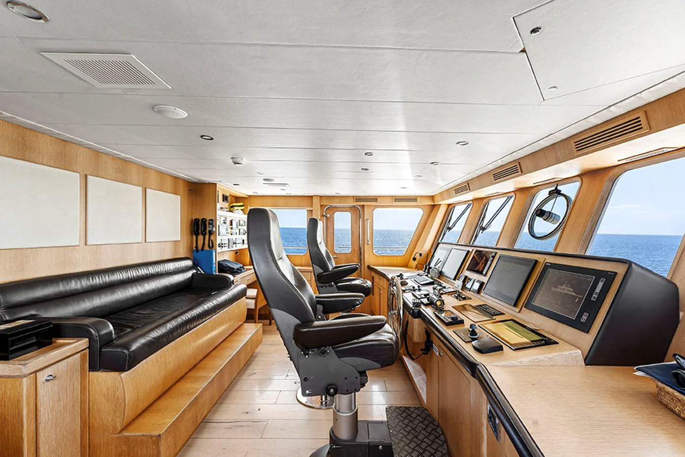 The helm station features advanced navigation equipment and comfortable seating with panoramic ocean views. aboard BANDIDO Yacht for Sale