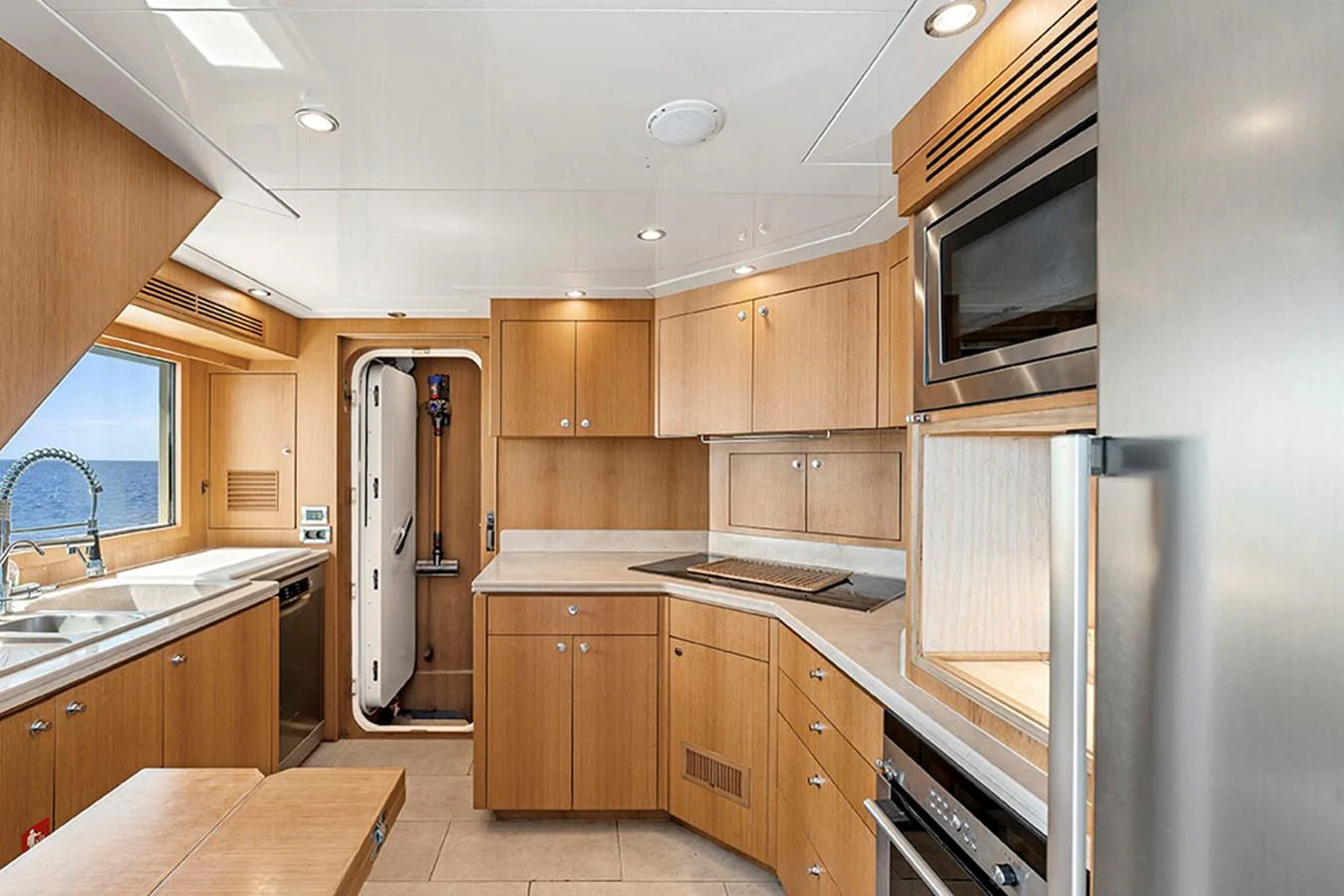 The yacht's galley features modern appliances and ample counter space with a view of the sea. aboard BANDIDO Yacht for Sale