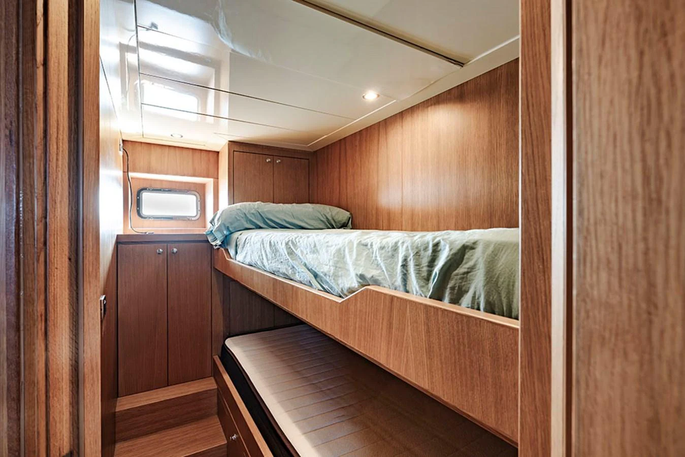 A cozy cabin with bunk beds and wood-paneled walls. aboard BANDIDO Yacht for Sale