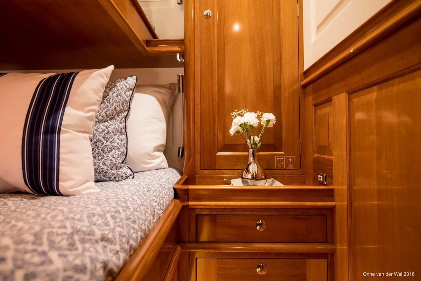 A cozy stateroom with elegant wooden cabinetry and plush bedding. aboard ACADIA Yacht for Sale
