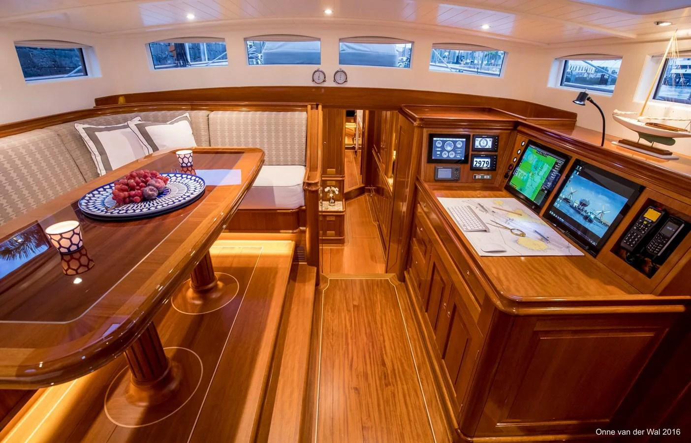 The yacht's saloon features elegant woodwork, a cozy dining area, and advanced navigation equipment. aboard ACADIA Yacht for Sale