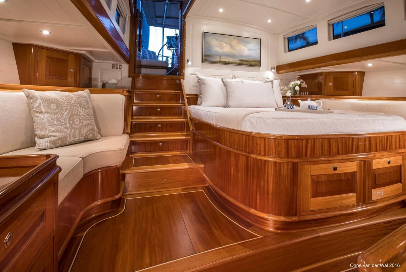 The master stateroom features luxurious wood finishes and elegant furnishings, creating a warm and inviting atmosphere. aboard ACADIA Yacht for Sale