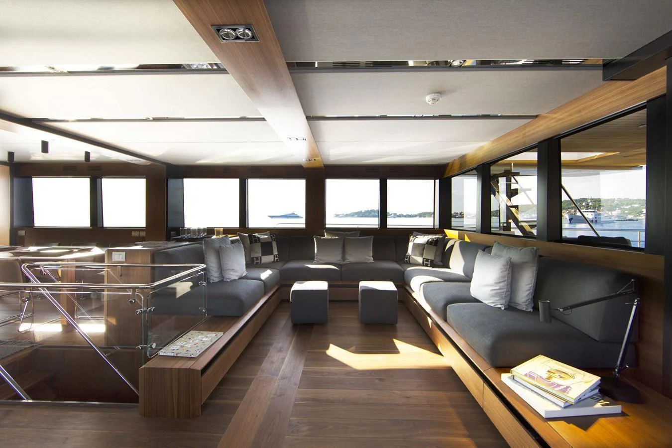 The salon features modern furnishings with ample seating and large windows offering panoramic views. aboard CASA Yacht for Sale