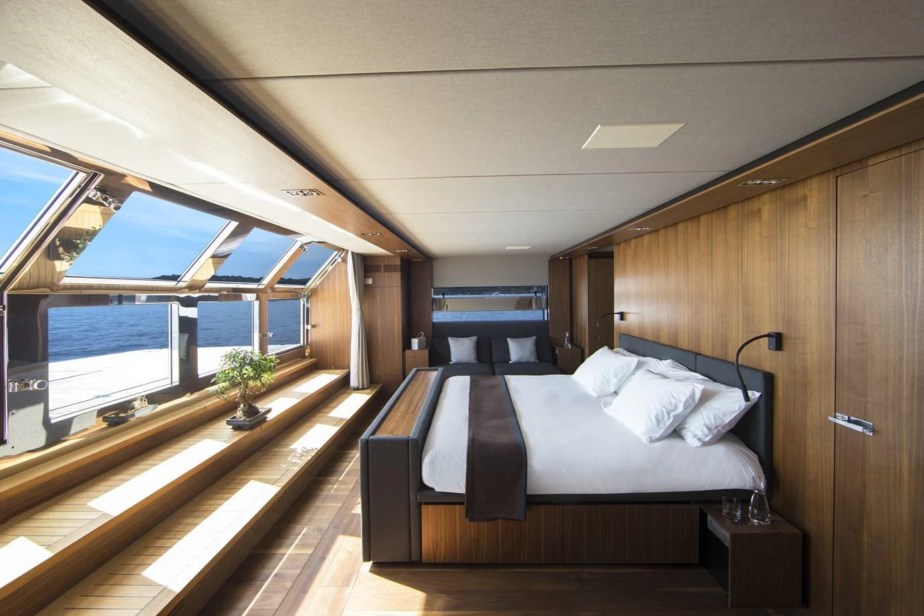 The master stateroom offers a luxurious and spacious retreat with panoramic views and elegant wood finishes. aboard CASA Yacht for Sale