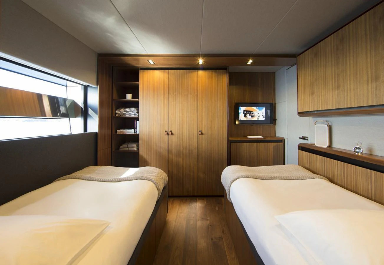 The twin stateroom offers a cozy and modern retreat with ample storage and natural light. aboard CASA Yacht for Sale