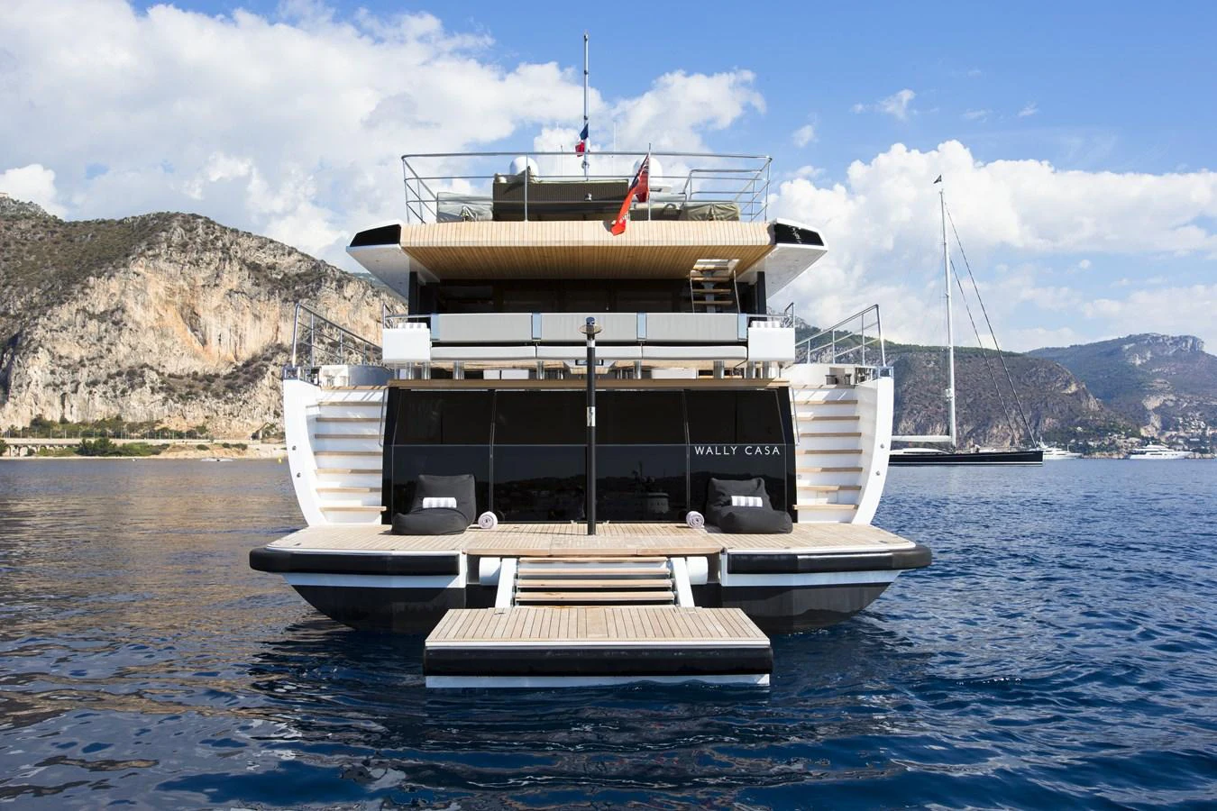 A luxurious yacht is moored in a scenic coastal area, showcasing its elegant design and spacious decks. aboard CASA Yacht for Sale
