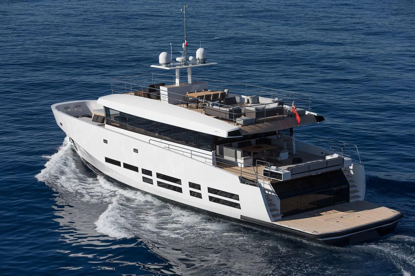 A sleek and modern yacht cruising on calm blue waters, showcasing its elegant design and spacious deck areas. aboard CASA Yacht for Sale