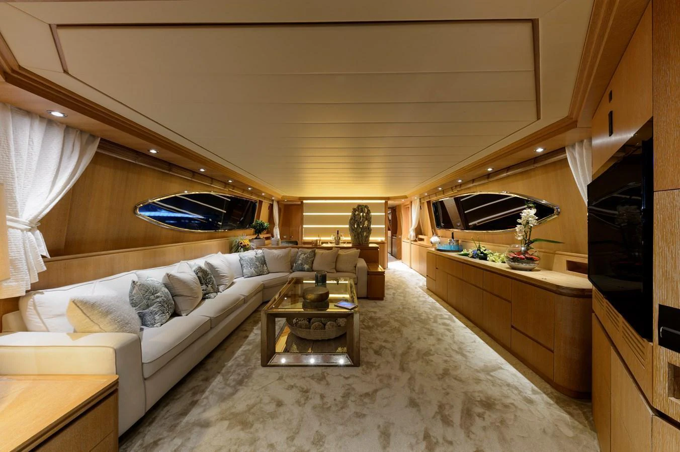 The salon features luxurious seating, elegant decor, and ample natural light. aboard AMAYA Yacht for Sale