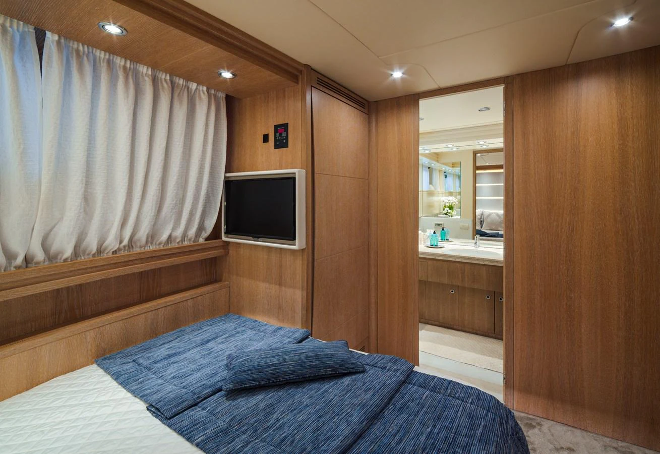 A cozy stateroom with a comfortable bed and an ensuite bathroom. aboard AMAYA Yacht for Sale