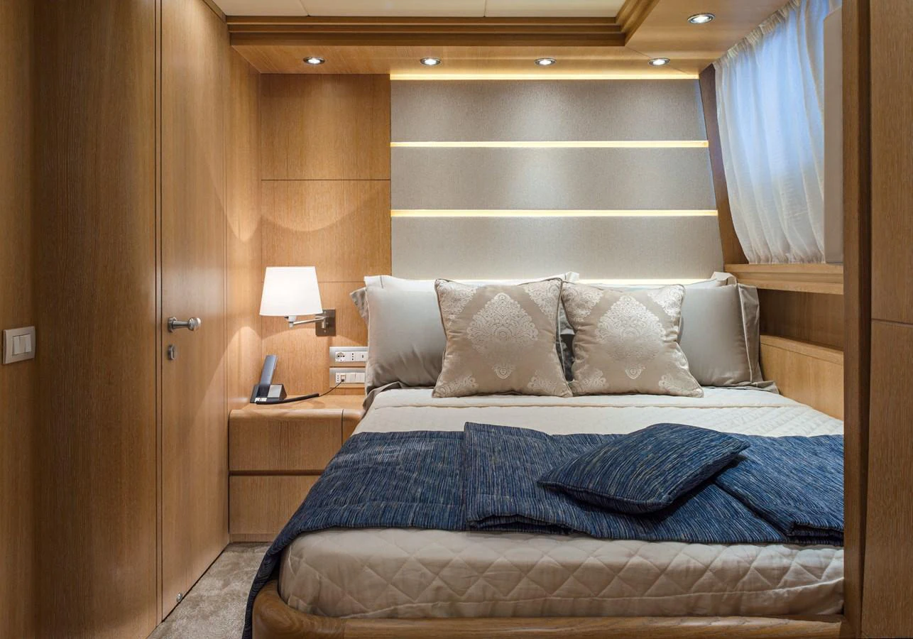 A cozy stateroom featuring a comfortable bed with elegant bedding and soft lighting. aboard AMAYA Yacht for Sale