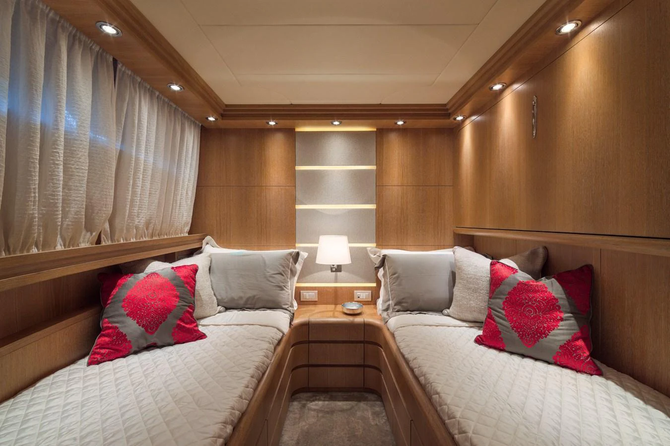The guest stateroom features twin beds with elegant bedding and warm wood paneling. aboard AMAYA Yacht for Sale